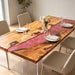 Olive wood dining table featuring a dramatic red resin swirl