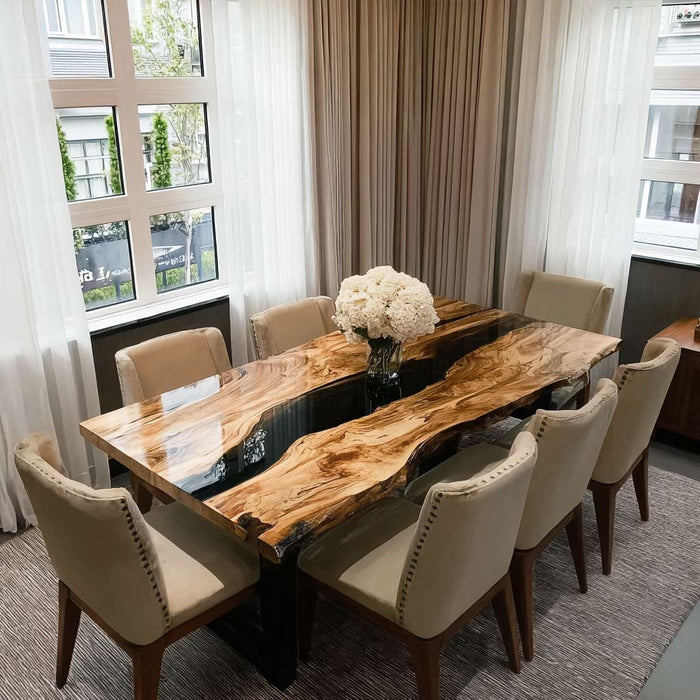 Olive wood dining table with natural grain and resin accents in a bright California dining space.