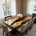 Olive wood dining table with natural grain and resin accents in a bright California dining space.