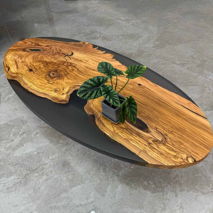 Wooden coffee table with a plant on a gray floor
