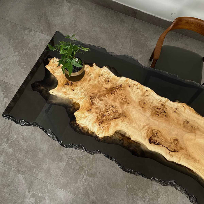 Top view of the S72 poplar wood live edge epoxy table displaying the smooth translucent black epoxy finish and organic wood grain.