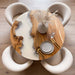 Custom round poplar wood dining table with white epoxy resin river design.