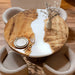 Custom round poplar wood dining table with white epoxy resin river design.