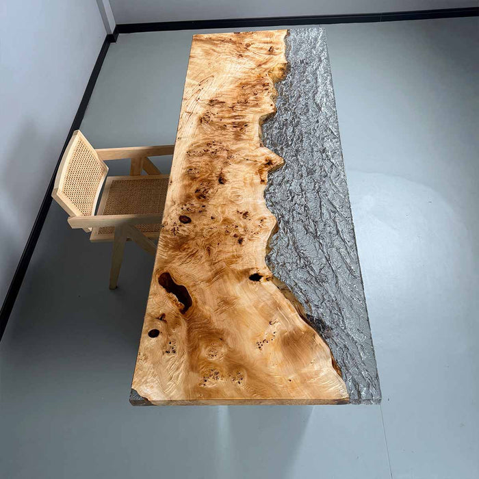 Wooden table with a gray epoxy resin inclusion in a minimalistic room.
