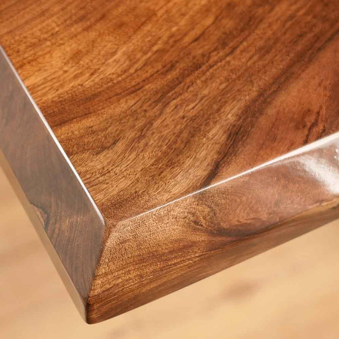 Close-up of a wooden surface with a metal edge