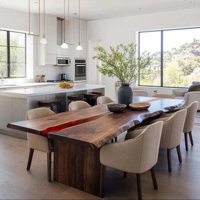 Modern kitchen with a wooden dining table and chairs, featuring a vase with greenery.