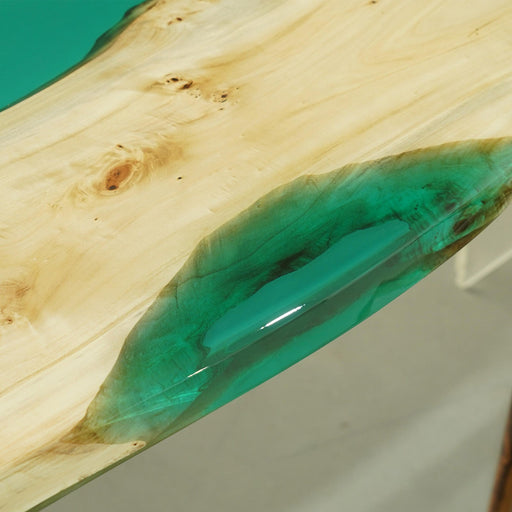Elegant epoxy resin table with natural wood and glossy green river effect.