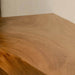 Close-up of a wooden surface with visible grain and texture.