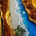 Aerial view of a beach with blue water and rocky shore.