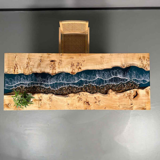 Wooden desk with a river design and chair on a gray background