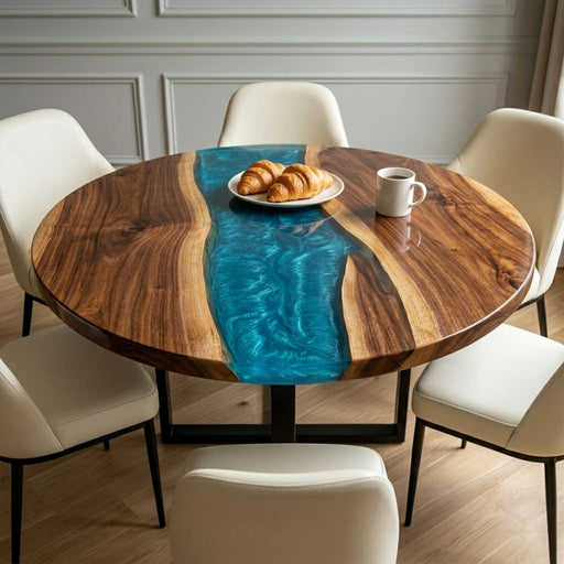 A luxury round black walnut coffee table with a deep blue swirl resin river in a modern living room.