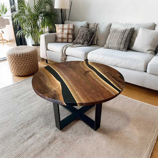 Wooden coffee table with black base in a living room setting