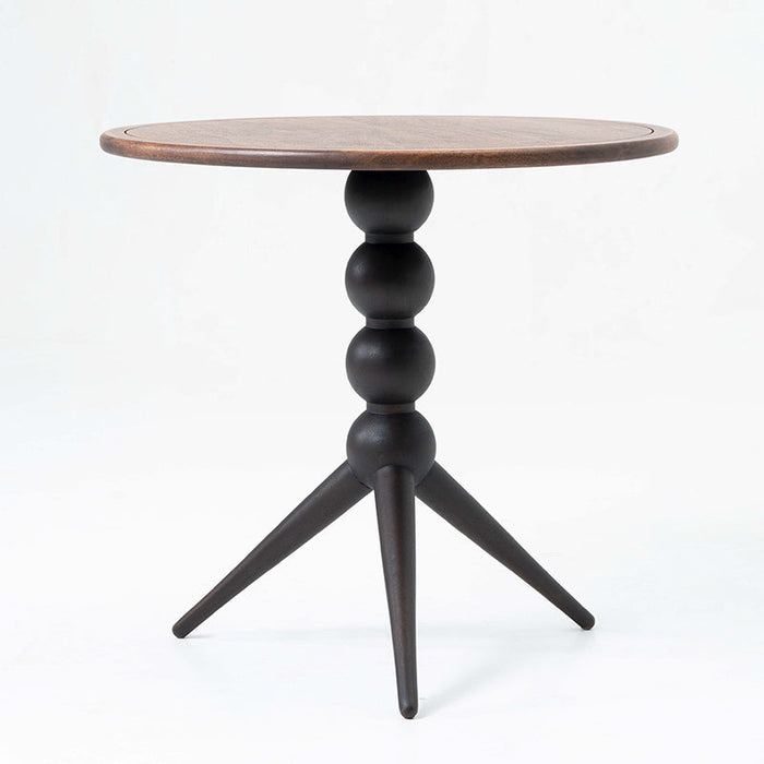 Minimalist round end table with warm wood top and artistic black legs for modern homes.
