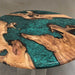 olive wood dining table featuring flowing green swirl resin