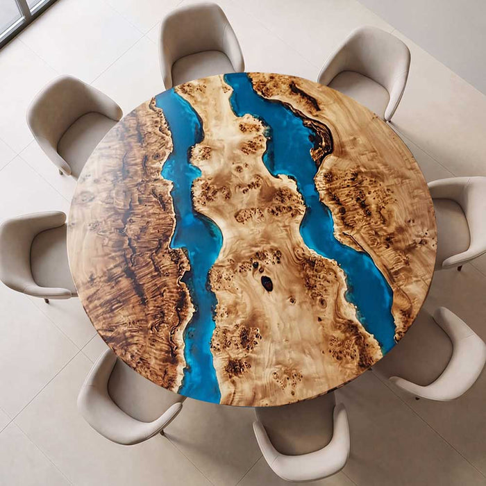 Luxury round resin river table styled with modern beige chairs in a sunlit room.