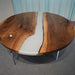 Round smoky gray epoxy dining table with natural walnut grain