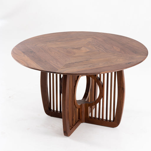 Round solid wood dining table with elegant handcrafted base
