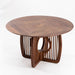 Round solid wood dining table with elegant handcrafted base