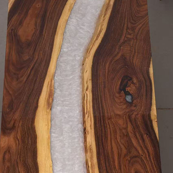 Close-up of a wooden cutting board with a natural grain pattern.