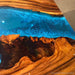 Modern coffee table for a Silicon Valley tech loft, featuring blue epoxy and walnut.