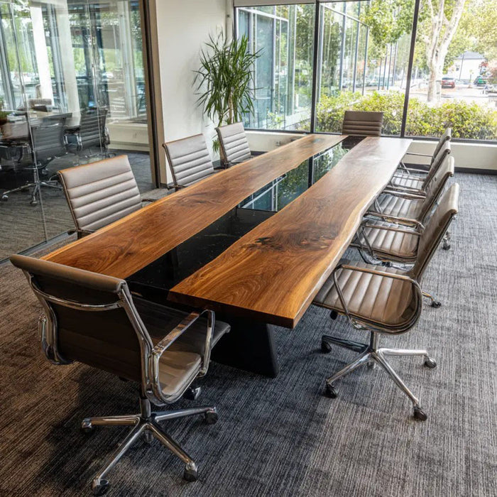 Long wooden conference table with chairs in a modern office setting
