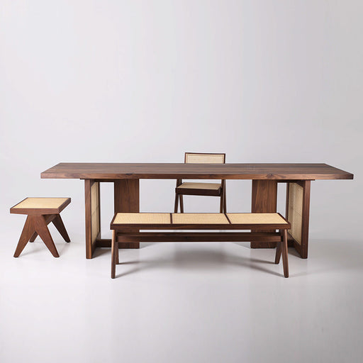 Modern solid wood walnut dining table with matching bench and chairs