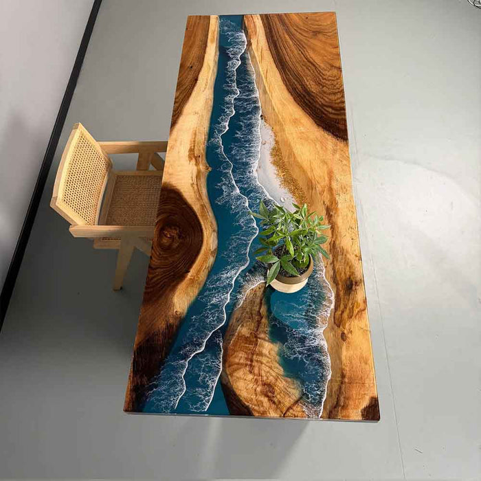 Wooden table with a river design embedded, placed on a gray floor.