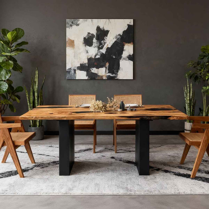 Dining room with wooden table, chairs, and abstract art on the wall.