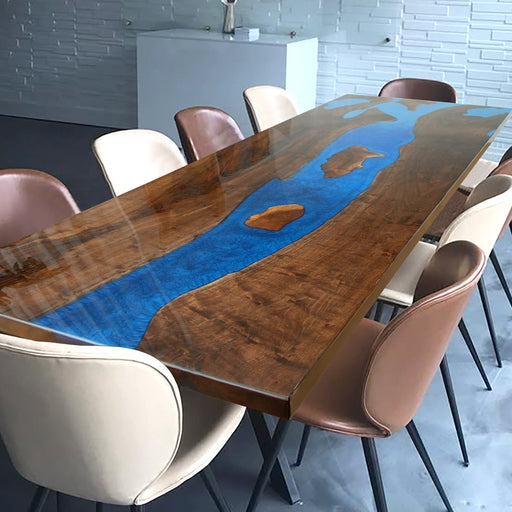 A captivating epoxy resin wood river table with dark wood grain and vibrant blue epoxy resin inlays, creating a striking visual effect.