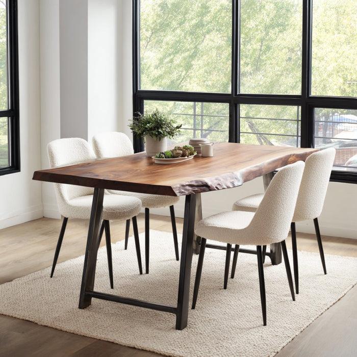 Dining room with a wooden table and white chairs near large windows.