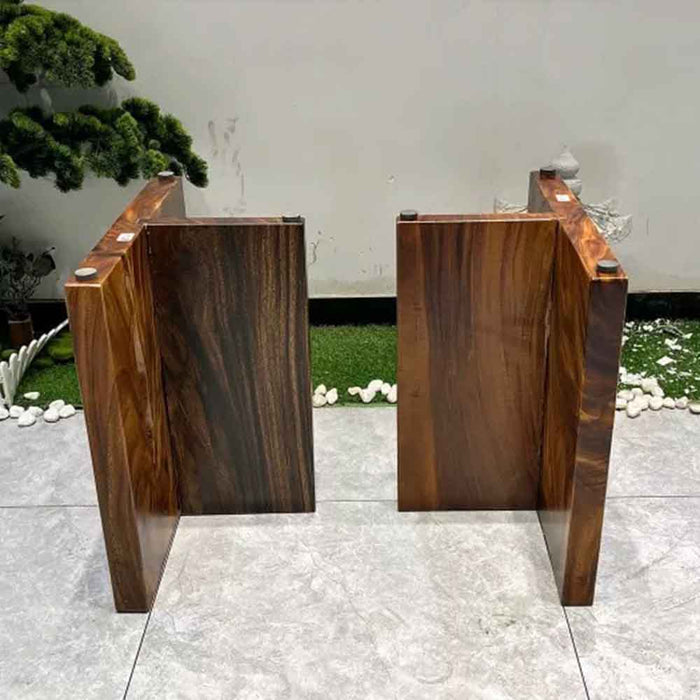 Two wooden podiums on a tiled floor with a white wall and plants in the background.