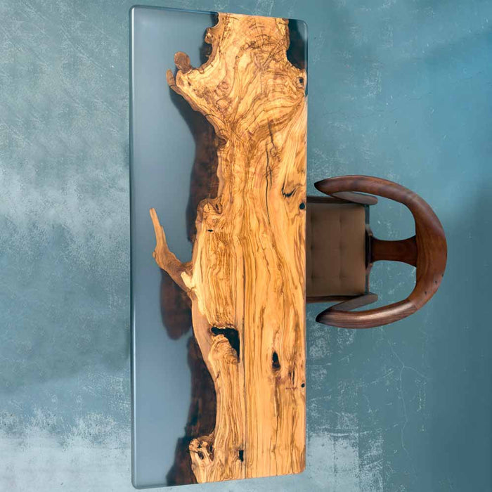 Wooden desk with natural grain pattern and a chair on a textured blue background