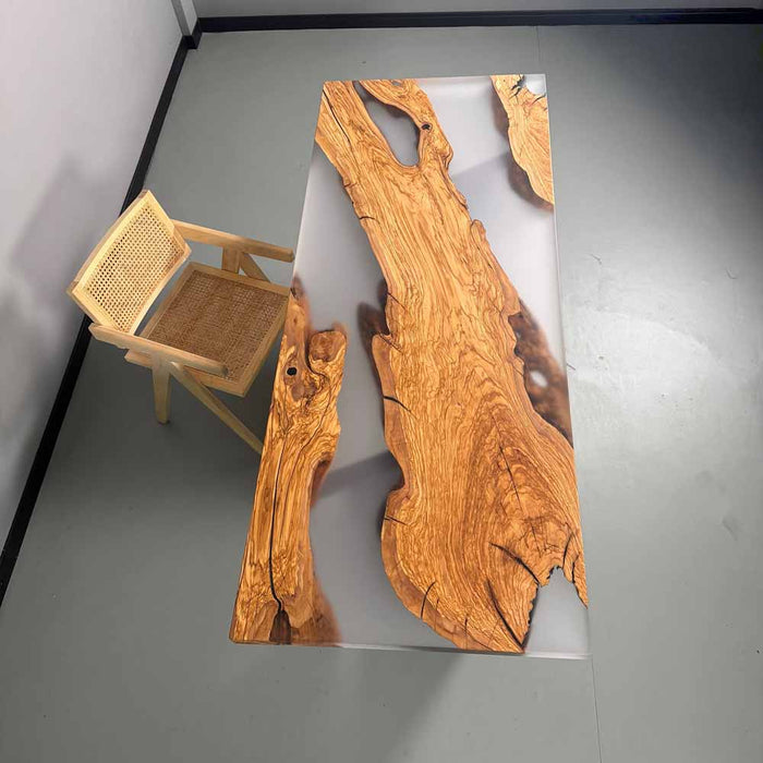 Wooden table with natural grain pattern and a small chair on a gray floor.