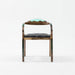 Chair with wooden frame, green backrest, and black seat on a white background