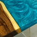 Close-up of a wooden surface with a blue resin finish