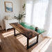 Dining room with a wooden table featuring a green resin finish, white curtains, and a white dresser.