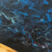 Unique walnut wood table with starry sky epoxy river design, perfect for elegant dining rooms.