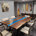 Modern conference room with a unique wooden table featuring a blue resin inlay.