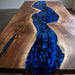 Wooden table with a blue resin river design