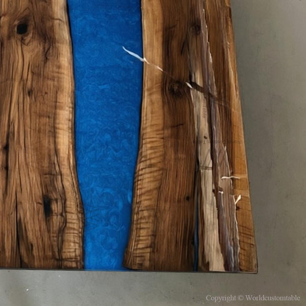 Close-up detail of ice fire epoxy resin blending with natural wood grain on a handcrafted conference table.