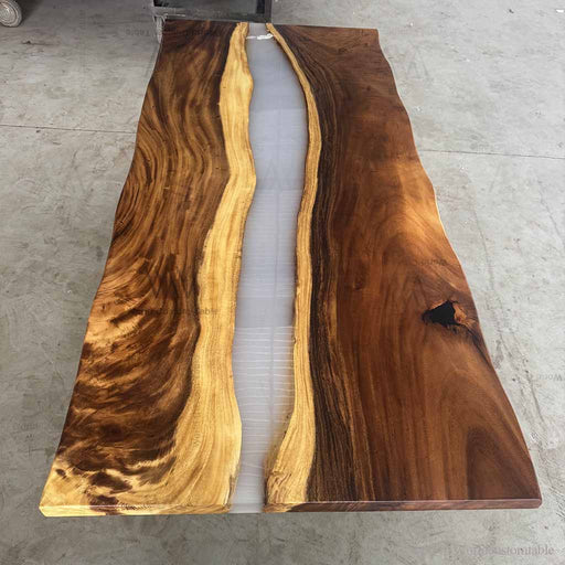 Wooden table with a natural grain pattern on a concrete floor.