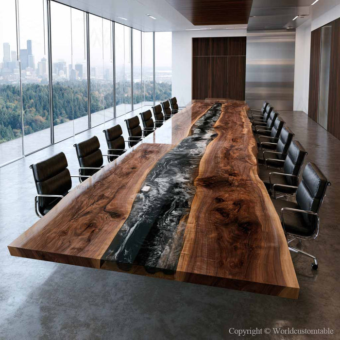A large modern conference table made of richly graded live-edge wood with a dark river stone or resin inlay running down the center, surrounded by black office chairs in a contemporary office setting with floor-to-ceiling windows.
