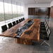 Luxury live edge black walnut conference table featuring a handcrafted black ocean wave epoxy river for modern executive offices.