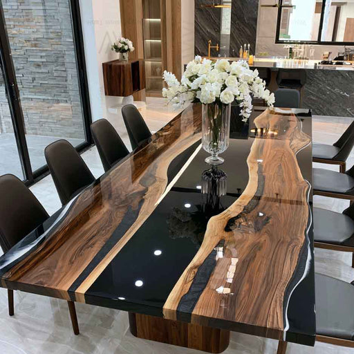 Handcrafted custom live edge black walnut resin dining table with rich natural wood grain and glossy black epoxy finish.