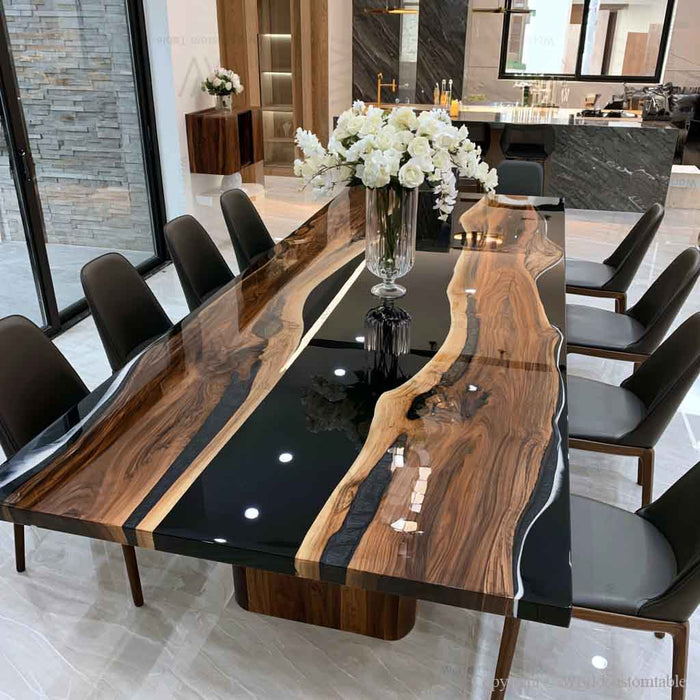 Handcrafted custom live edge black walnut resin dining table with rich natural wood grain and glossy black epoxy finish.