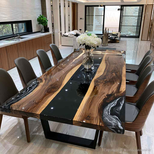 Luxury walnut dining table featuring a polished black epoxy river and handcrafted live edge wood for contemporary interiors.