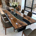 Solid black walnut river table combining organic live edge wood with a sleek black epoxy resin centerpiece.