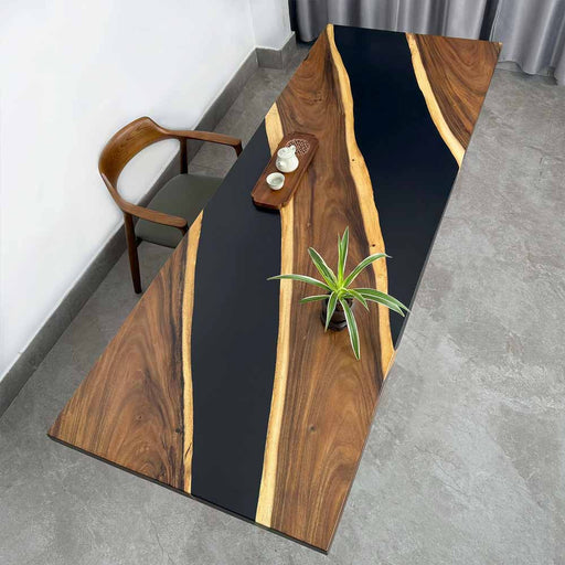 Wooden dining table with black resin inlay in a modern interior setting