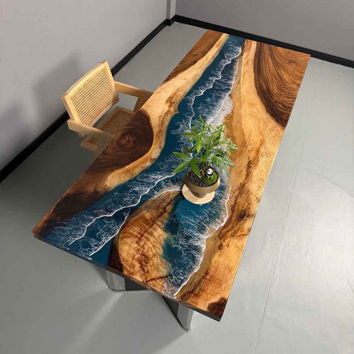 Wooden table with epoxy resin design resembling a river, placed in a minimalistic room.
