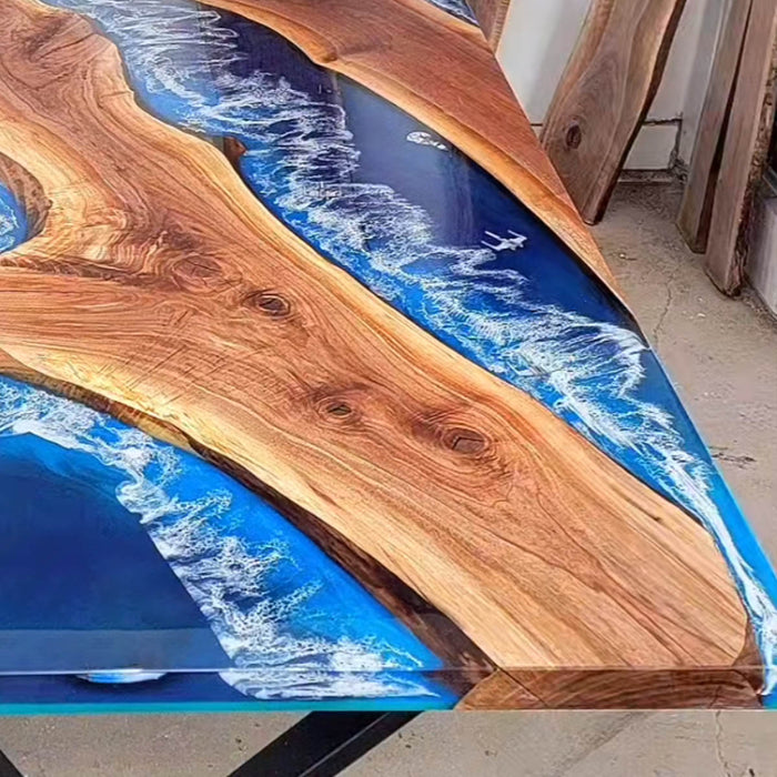 Live edge walnut table with ocean wave-style blue epoxy resin and natural wood grain
